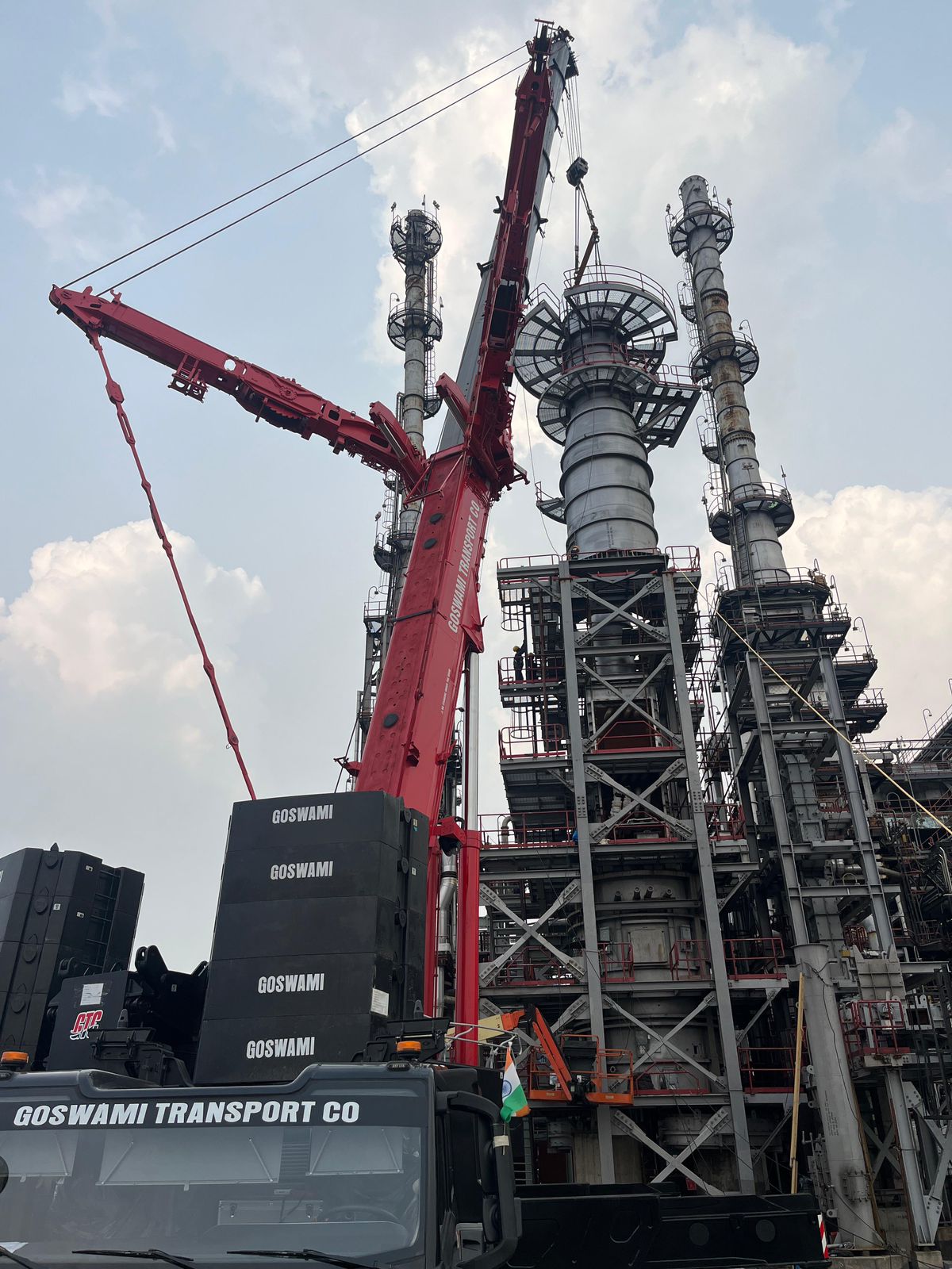 Crane erection alongside refinery process towers